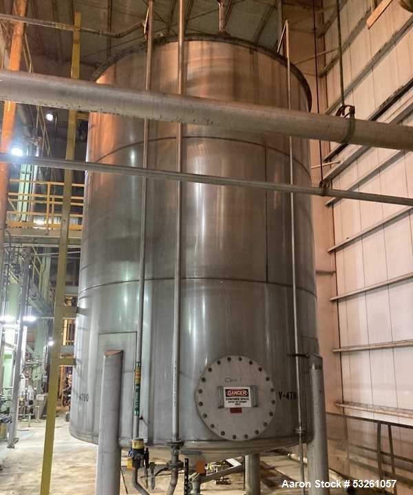 Used Approximate 9000 gallon Stainless Steel Storage Tank With 5 HP Centrifugal Pump, V-4780. approximate 120' X 15' T/T. Misc. top inlets. Cone bottom with center bottom outlet. Bottom side manway. ...