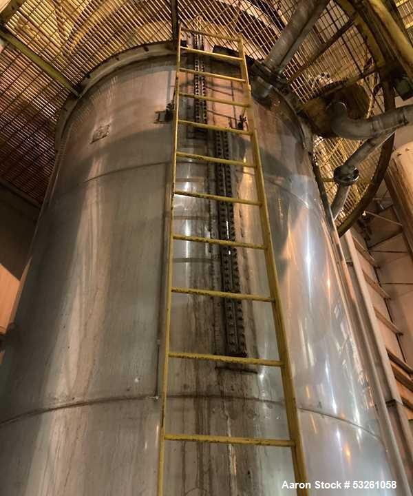 Used Approximate 6,750 gallon Stainless Steel Tank With Diaphragm Pump, V-4332. Flat top with misc. inlets & openings. Cone bottom with center bottom outlet. Side bottom manway. Has stainless steel l...