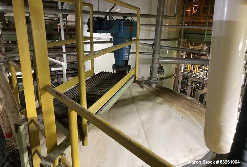 Used Approximate 8000 gallon Stainless Steel Mixing Tank With Centrifugal Pump, V-4506. Flat top with misc. top inlets. Cone bottom with center bottom outlet. Insulated shell. Top entering Chemineer ...