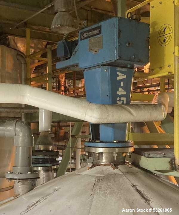 Used Approximate 8000 gallon Stainless Steel Mixing Tank With Centrifugal Pump, V-4505. Flat top with misc. top inlets. Cone bottom with center bottom outlet. Insulated shell. Top entering Chemineer ...