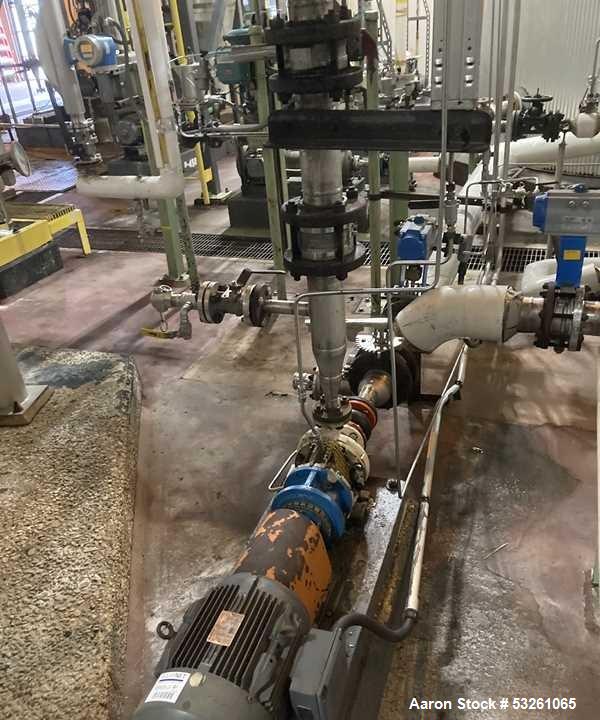 Used Approximate 8000 gallon Stainless Steel Mixing Tank With Centrifugal Pump, V-4505. Flat top with misc. top inlets. Cone bottom with center bottom outlet. Insulated shell. Top entering Chemineer ...