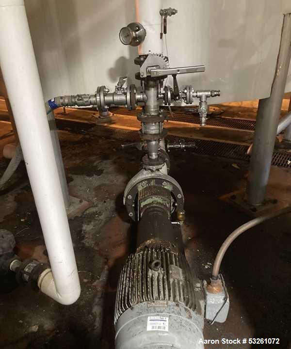 Used Approximate 5200 gallon Stainless Steel Mixing Tank. 12C. Includes centrifugal pump.