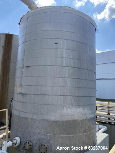 approximately 9000 gallon stainless steel vertical storage tank.