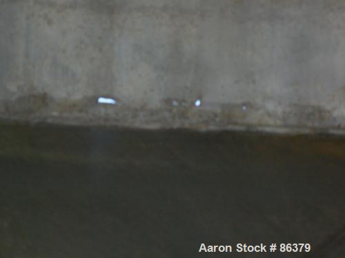 USED: Tank, 10,000 gallon, 304 stainless steel, vertical. Approximate 11' diameter x 14' straight side. Coned top, sloped bottom. Openings: top 18" manway with cover, 3-1/2", 6", 4"; 16" x 20" side o...