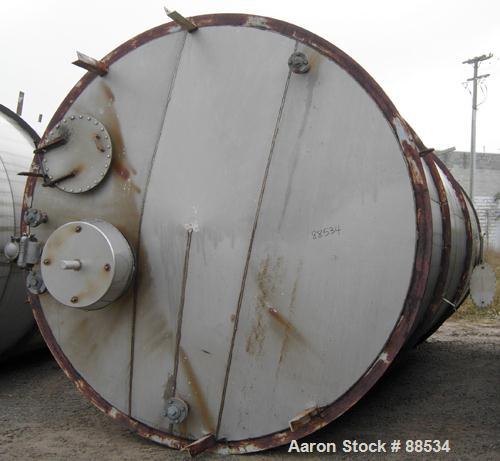 USED: Tank, 18,000 gallon, stainless steel. Approximate 10'6" diameter x 27'6" straight side. Slight cone top and flat bottom. Top openings: (3) 2", (2) 3", (1) 15", (1) 20" manway with cover. Side o...