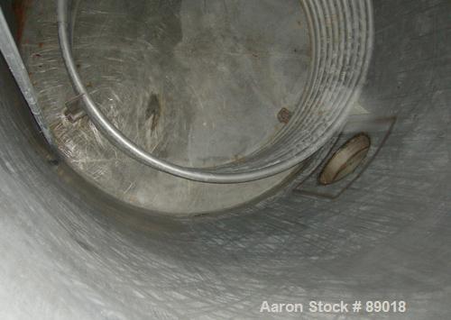 USED: Tank, 11,700 gallon, 304 stainless steel, vertical. Approximately 132" diameter x 198" straight side. Dished top, flat bottom. 10 turns of approximate 3" pipe coil. Openings: top 1-1/2", 4", 6"...