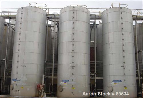USED: Tank, 25,000 gallon, 316 stainless steel, vertical. 144" diameter x 360" straight side. Conical top, flat bottom. Openings: (1) 18" top, (1) 18" side manway, (1) 6" side bottom outlet.