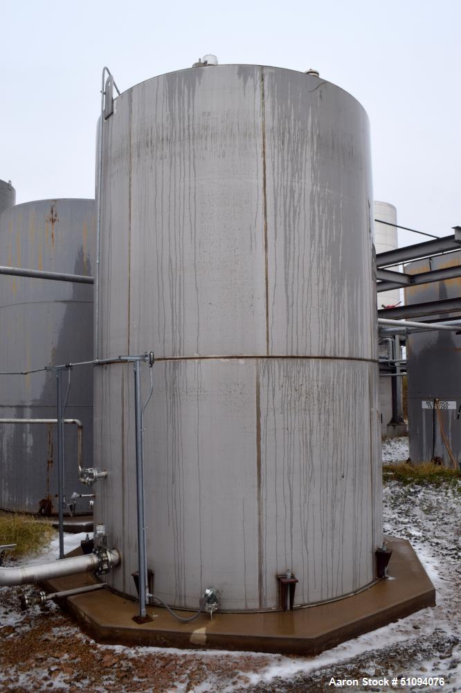 Used A&B Process Tank, 15,000 Gallon, 304L Stainless Steel, Vertical. Approximate 144" diameter x 216" straight side, top, flat bottom.  Openings top 3", 4" side (5) 2", 24" man way with davit arm an...