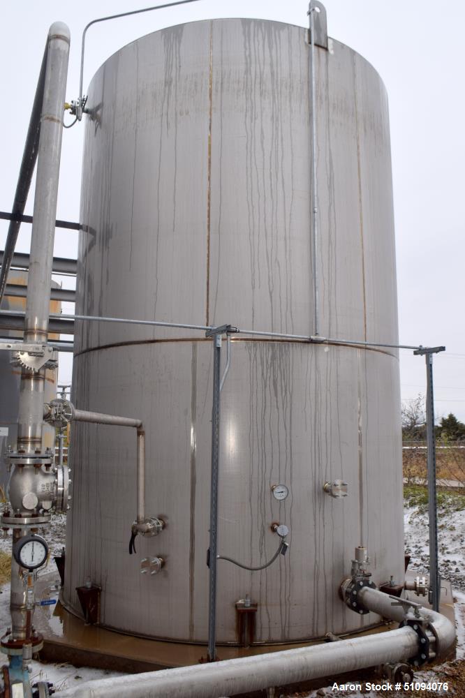 Used A&B Process Tank, 15,000 Gallon, 304L Stainless Steel, Vertical. Approximate 144" diameter x 216" straight side, top, flat bottom.  Openings top 3", 4" side (5) 2", 24" man way with davit arm an...