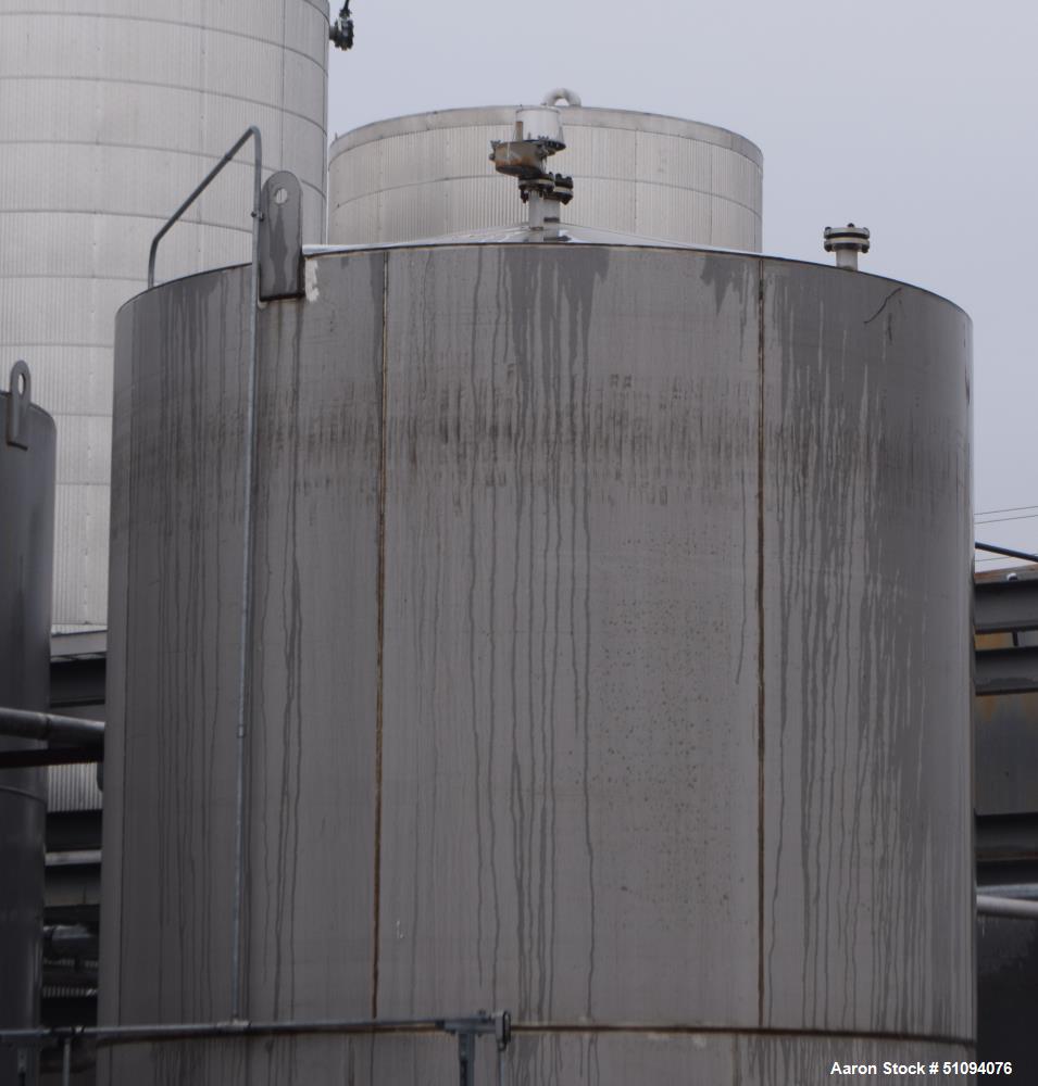Used A&B Process Tank, 15,000 Gallon, 304L Stainless Steel, Vertical. Approximate 144" diameter x 216" straight side, top, flat bottom.  Openings top 3", 4" side (5) 2", 24" man way with davit arm an...