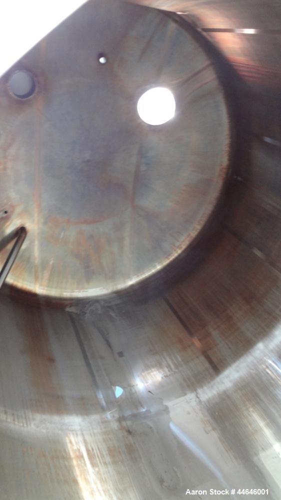 Used APV Crepaco Tank, Approximately 11,000 gallons, 304 Stainless Steel, Vertical. Approximate 138” diameter x 164” straight side, dished top, coned bottom. Approximate 60” wide section of bottom si...