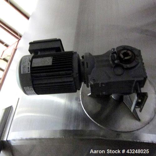 Used Apache Tank, 6500 Gallon, 316 Stainless Steel, Vertical. Approximate 102” diameter x 172” straight side. Dished top, 70” coned bottom. Side entering agitator with a 3 blade prop, driven by a 3hp...