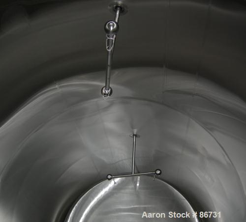 USED: C E Howard tank, 10,000 gallon, 304 stainless steel, horizontal. 110" diameter x 245" straight side, dished heads. Approximately 1/2 of bottom channel jacketed. 4 spray balls. 21" x 18" oval en...