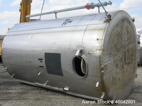 Used: C.E. Howard Tank, 5000 Gallon, 304 Stainless Steel, Vertical.  94" diameter x 165" straight side.  Dish top, flat bottom.  16" x 20" side oval manway with cover.  Top Openings:  8" flange, 6", ...
