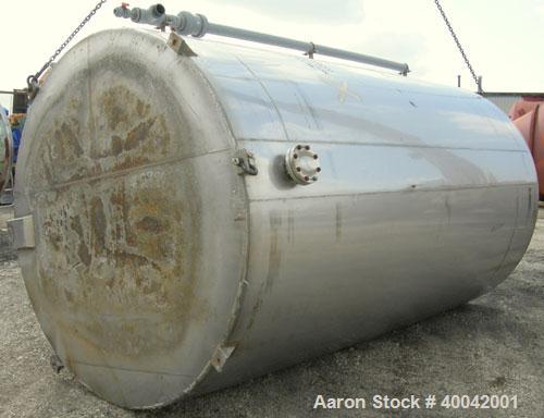 Used: C.E. Howard Tank, 5000 Gallon, 304 Stainless Steel, Vertical.  94" diameter x 165" straight side.  Dish top, flat bottom.  16" x 20" side oval manway with cover.  Top Openings:  8" flange, 6", ...