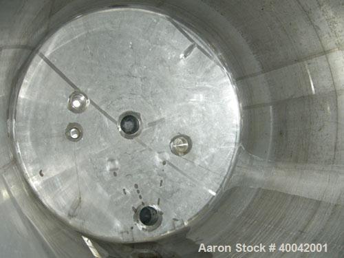 Used: C.E. Howard Tank, 5000 Gallon, 304 Stainless Steel, Vertical.  94" diameter x 165" straight side.  Dish top, flat bottom.  16" x 20" side oval manway with cover.  Top Openings:  8" flange, 6", ...