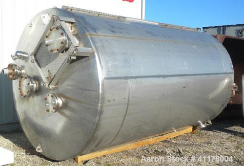 Used Used C.E. Howard Tank, 5000 Gallon, 304 Stainless Steel, Vertical. 94"
diameter x 165" straight side, dish top, sloped bottom. Openings: top 8", (2) 6", 10"; side 16" x 20" bottom oval manway wi...