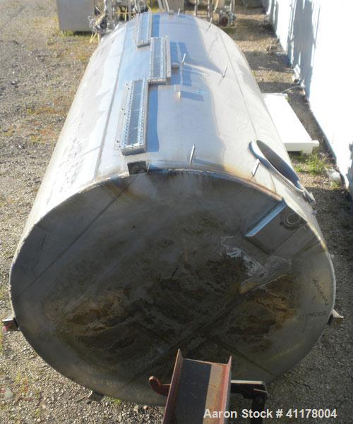 Used Used C.E. Howard Tank, 5000 Gallon, 304 Stainless Steel, Vertical. 94"
diameter x 165" straight side, dish top, sloped bottom. Openings: top 8", (2) 6", 10"; side 16" x 20" bottom oval manway wi...