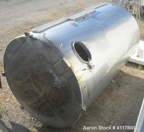 Used Used C.E. Howard Tank, 5000 Gallon, 304 Stainless Steel, Vertical. 94"
diameter x 165" straight side, dish top, sloped bottom. Openings: top 8", (2) 6", 10"; side 16" x 20" bottom oval manway wi...
