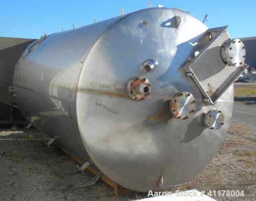 Used Used C.E. Howard Tank, 5000 Gallon, 304 Stainless Steel, Vertical. 94"
diameter x 165" straight side, dish top, sloped bottom. Openings: top 8", (2) 6", 10"; side 16" x 20" bottom oval manway wi...