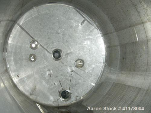 Used Used C.E. Howard Tank, 5000 Gallon, 304 Stainless Steel, Vertical. 94"
diameter x 165" straight side, dish top, sloped bottom. Openings: top 8", (2) 6", 10"; side 16" x 20" bottom oval manway wi...