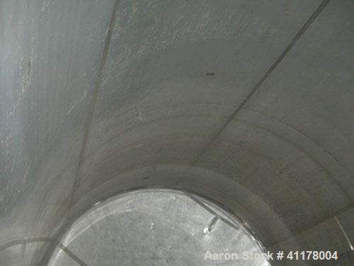 Used Used C.E. Howard Tank, 5000 Gallon, 304 Stainless Steel, Vertical. 94"
diameter x 165" straight side, dish top, sloped bottom. Openings: top 8", (2) 6", 10"; side 16" x 20" bottom oval manway wi...