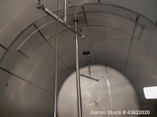 Used Cherry Burrell 10,000 Gallon Stainless Steel Horizontal Storage Tank. Approximately 10'6" diameter x 14'6" straight side. Dished heads. 16" x 20" side oval manway with cover. 3" EBO. (2) Dual CI...