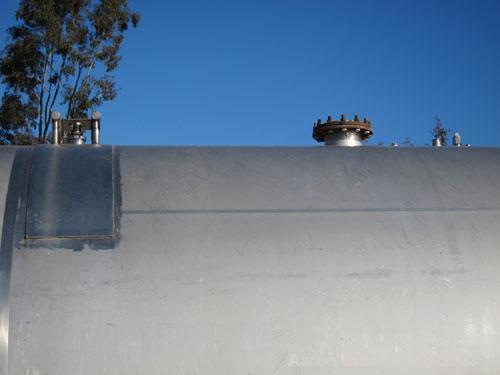 Used Cherry Burrell 10,000 Gallon Stainless Steel Horizontal Storage Tank. Approximately 10'6" diameter x 14'6" straight side. Dished heads. 16" x 20" side oval manway with cover. 3" EBO. (2) Dual CI...