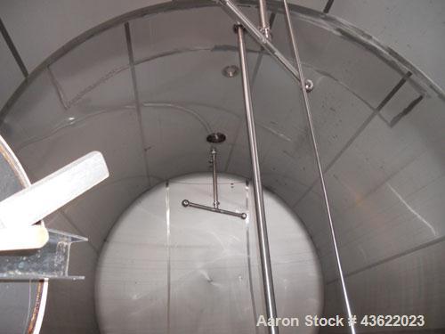 Used Cherry Burrell 10,000 Gallon Stainless Steel Horizontal Storage Tank. Approximately 10'6" diameter x 14'6" straight side. Dished heads. 16" x 20" side oval manway with cover. 3" EBO. (2) Dual CI...