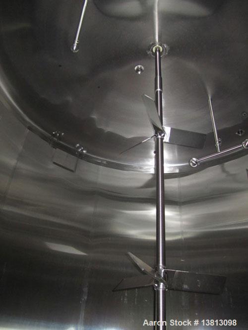 Used Cherry Burrell 8000 Gallon Vertical Stainless Steel Tank.Top mounted agitator, side manway, sightglass, 3" sloped bottom side discharge, 12'2" diameter x 10' straight wall, 14'8" overall height.