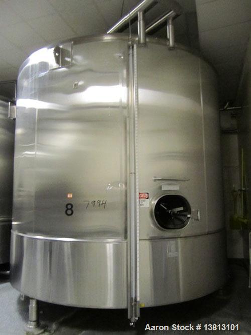 Used Cherry Burrell 8000 Gallon Vertical Stainless Steel Tank.Top mounted agitator, dual impeller, bearing block, side manway, sightglass, 3" center bottom discharge, 12'9" overall width x 10'10" str...