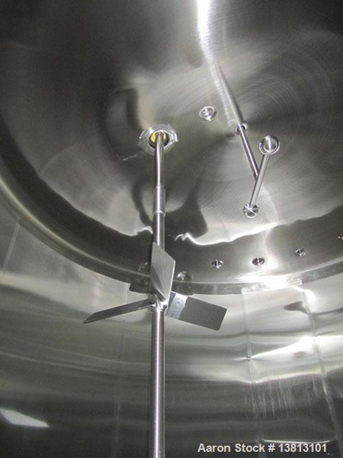 Used Cherry Burrell 8000 Gallon Vertical Stainless Steel Tank.Top mounted agitator, dual impeller, bearing block, side manway, sightglass, 3" center bottom discharge, 12'9" overall width x 10'10" str...
