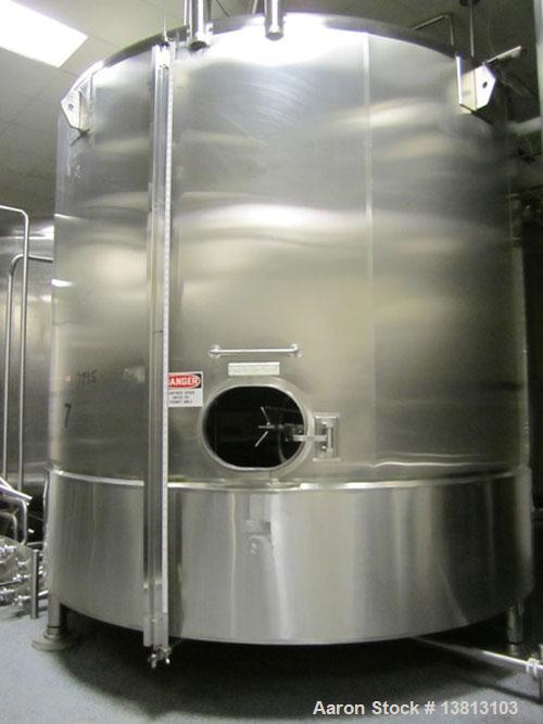 Used Cherry Burrell 8000 Gallon Vertical Stainless Steel Tank.Top mounted agitator, dual impeller, bearing block, side manway, sightglass, 3" center bottom discharge, 12'9" overall width x 10'10" str...