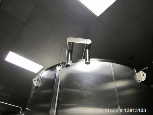 Used Cherry Burrell 8000 Gallon Vertical Stainless Steel Tank.Top mounted agitator, dual impeller, bearing block, side manway, sightglass, 3" center bottom discharge, 12'9" overall width x 10'10" str...