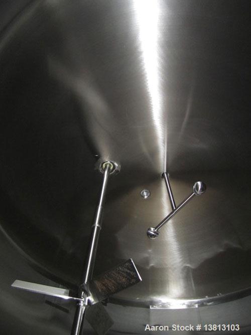 Used Cherry Burrell 8000 Gallon Vertical Stainless Steel Tank.Top mounted agitator, dual impeller, bearing block, side manway, sightglass, 3" center bottom discharge, 12'9" overall width x 10'10" str...