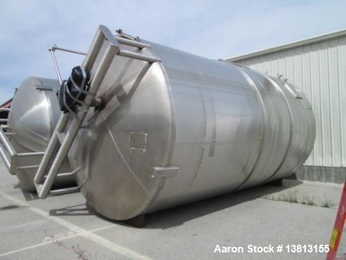 Used- Cherry Burell 15,000 Gallon, Vertical, All Stainless Steel Tank. Has top mounted agitator, flat bottom, dish top (dent...