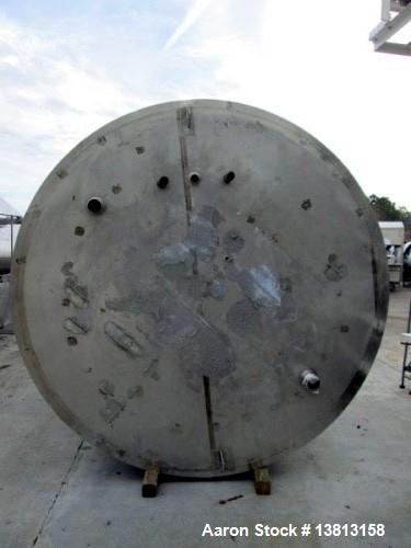 Used 6,000 Gallon Stainless Steel Storage Tank. Approximately 98'' diameter x 16' straight wall, side manhole. Inlets 2 - 3'' threaded 2 - 1.5'' threaded. Outlets 3'' threaded.