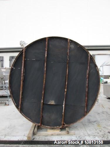 Used 6,000 Gallon Stainless Steel Storage Tank. Approximately 98'' diameter x 16' straight wall, side manhole. Inlets 2 - 3'' threaded 2 - 1.5'' threaded. Outlets 3'' threaded.