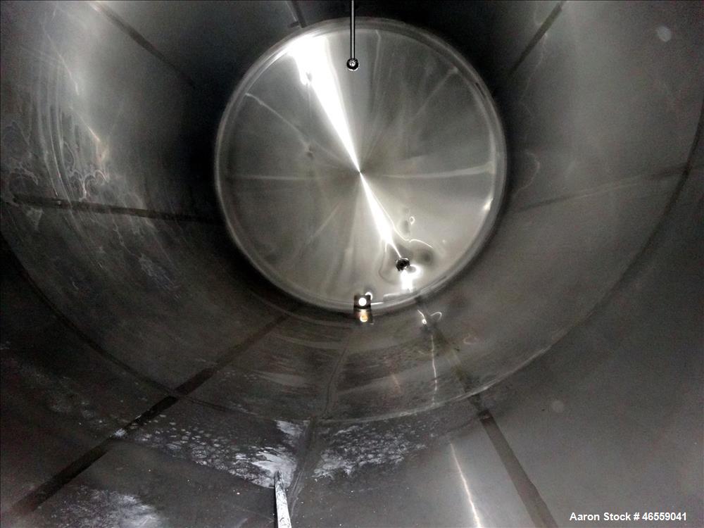 Used Crepaco Industries Tank, Approximately 10,000 gallon, 304 Stainless Steel, Horizontal. Approximate 124" diameter x 196" straight side. Dished heads. Openings: 20" x 16" oval manway with cover. T...