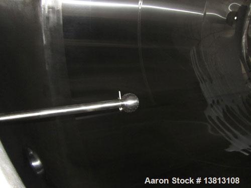Used DCI Insulated Stainless Steel Mixing Tank, 6,000 Gallon.  Top agitated, flat bottom, stainless steel, top manway and 1 spray ball.  4 Top inlets:  (2) 5", (1) 8", (1) 2";  3 outlets:  2.5", 3" a...