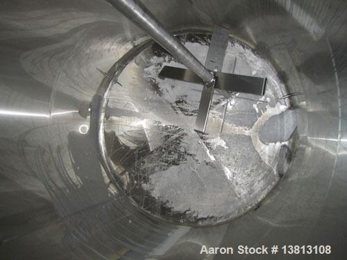 Used DCI Insulated Stainless Steel Mixing Tank, 6,000 Gallon.  Top agitated, flat bottom, stainless steel, top manway and 1 spray ball.  4 Top inlets:  (2) 5", (1) 8", (1) 2";  3 outlets:  2.5", 3" a...