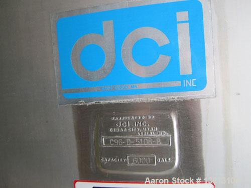 Used DCI Insulated Stainless Steel Mixing Tank, 6,000 Gallon.  Top agitated, flat bottom, stainless steel, top manway and 1 spray ball.  4 Top inlets:  (2) 5", (1) 8", (1) 2";  3 outlets:  2.5", 3" a...