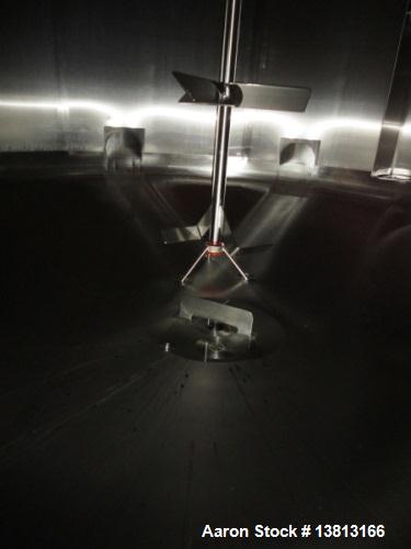 Used 6,000 Gallon Top Agitated Mixing Tank. Single shell top agitated mixing tank with dual 28" paddles. Dish top and bottom, (8) stainless legs, bottom side manway, 3" tri-clamp discharge, dual CIP ...