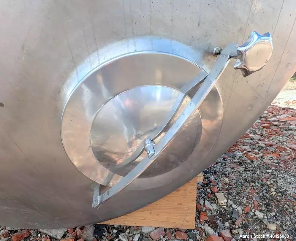 Used Feldmeier 12,000 Gallon Storage Tank. 316 stainless steel construction. Approximately 136" inner diameter x 180"straight side, dish top and bottom, 20" top manway, 3" center bottom outlet. Mount...