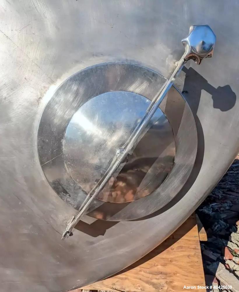 Used Feldmeier 12,000 Gallon Storage Tank. 316 stainless steel construction. Approximately 136" inner diameter x 180"straight side, dish top and bottom, 20" top manway, 3" center bottom outlet. Mount...