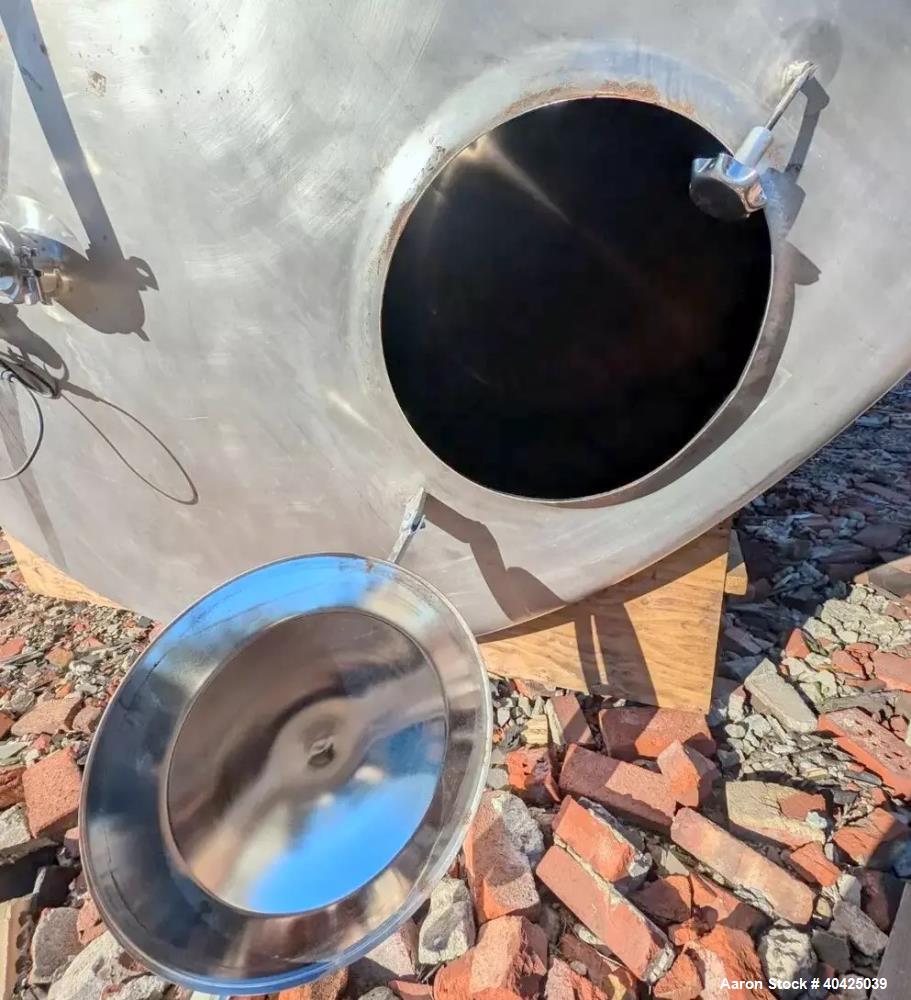 Used Feldmeier 12,000 Gallon Storage Tank. 316 stainless steel construction. Approximately 136" inner diameter x 180"straight side, dish top and bottom, 20" top manway, 3" center bottom outlet. Mount...