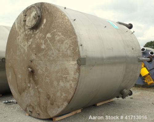 Used Filpaco Industries Tank, Approximate 6,000 Gallon, 304 Stainless Steel, Vertical.  Approximate 114" diameter x 132" straight side, slight cone top, slight dish bottom.  Top openings:  20" manway...
