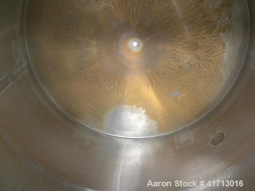 Used Filpaco Industries Tank, Approximate 6,000 Gallon, 304 Stainless Steel, Vertical.  Approximate 114" diameter x 132" straight side, slight cone top, slight dish bottom.  Top openings:  20" manway...