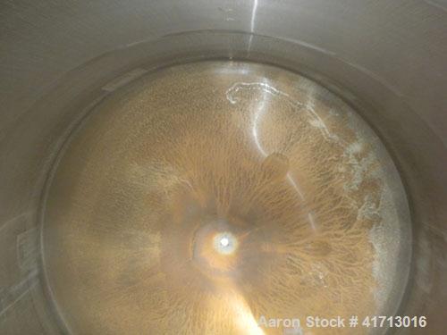 Used Filpaco Industries Tank, Approximate 6,000 Gallon, 304 Stainless Steel, Vertical.  Approximate 114" diameter x 132" straight side, slight cone top, slight dish bottom.  Top openings:  20" manway...