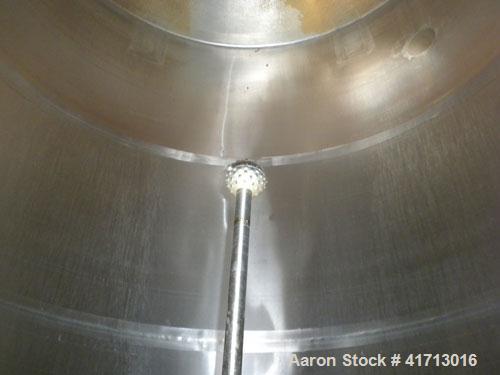 Used Filpaco Industries Tank, Approximate 6,000 Gallon, 304 Stainless Steel, Vertical.  Approximate 114" diameter x 132" straight side, slight cone top, slight dish bottom.  Top openings:  20" manway...